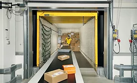 Worker handling packages on conveyor belt