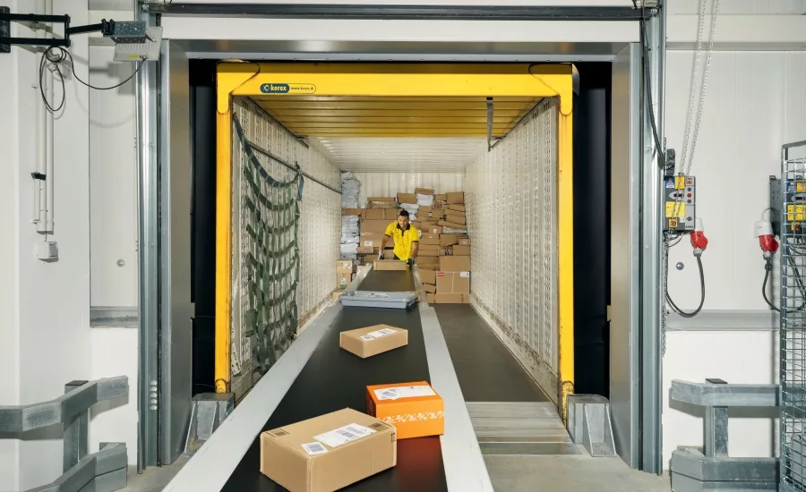 Worker handling packages on conveyor belt