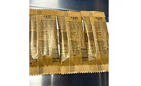 The back of three individual Cox & Co. candy bars in flow wrap paper packaging.