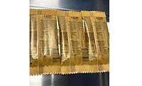 The back of three individual Cox & Co. candy bars in flow wrap paper packaging.