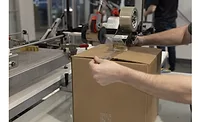 Worker seals a case using Shurtape's rPET packaging tape