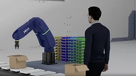 Image of person watching robotic arm in action.