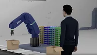 Image of person watching robotic arm in action.