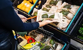 Person grabbing Sainsbury’s avocados at the grocery store.