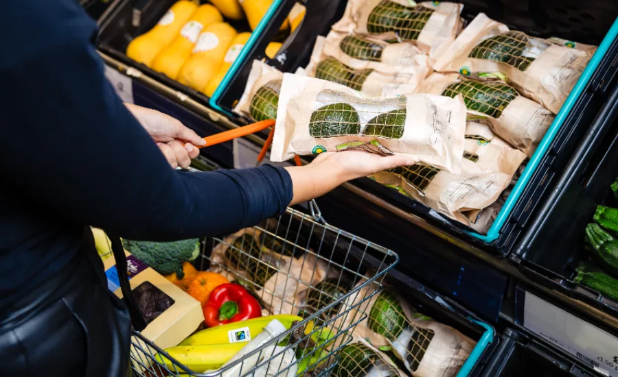 Person grabbing Sainsbury’s avocados at the grocery store.