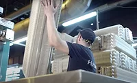 Image of Huhtamaki employee working with molded fiber products.