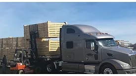 Image of pallets being loaded onto a truck.