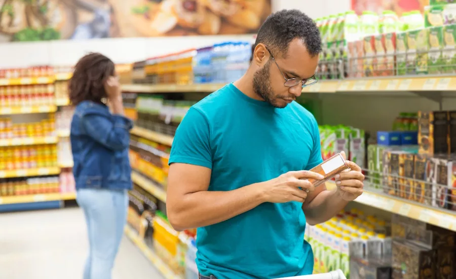 Supermarket shopper analyzing information on package