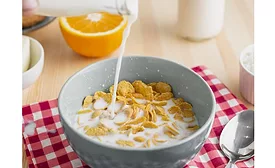 Image of milk being poured over a breakfast cereal