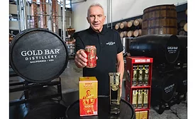 Joe Montana showing Gold Bar Whiskey’s new canned packaging.