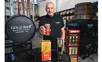 Joe Montana showing Gold Bar Whiskey’s new canned packaging.