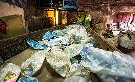 Plastic garbage on a conveyor belt at a waste recycling facility