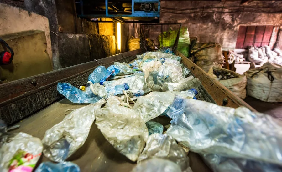 Plastic garbage on a conveyor belt at a waste recycling facility