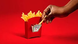 Image of the HEINZ Dipper, a first-of-its-kind fry box with a built-in ketchup compartment engineered for dipping on-the-go.