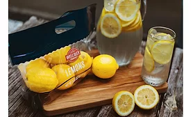 Image of lemons in a standup pouch next to a pitcher of lemonade
