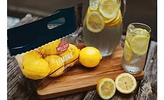 Image of lemons in a standup pouch next to a pitcher of lemonade