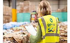 Worker auditing recyclable packaging materials at a Go-Pak facility.