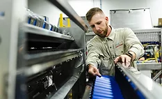 Technician reviews the cross conveyor on a Newtec weigher inside the Fox Solutions facility.