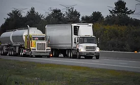 Image of trailer trucks on highway.
