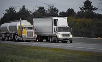Image of trailer trucks on highway.