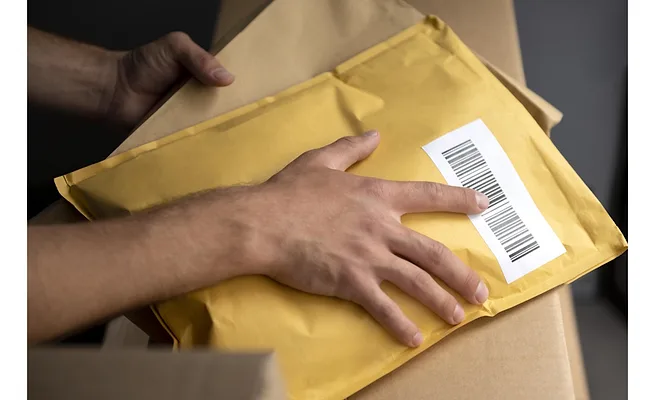 hand-holding-pack Close-up of person holding a packaging mailer