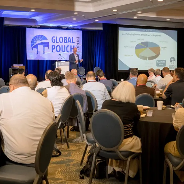 A man with a microphone speaks at Global Pouch Forum