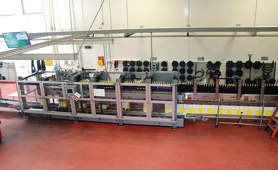 30 wine bottles are vertically loaded through plastic fingers that guide the bottles into the cases