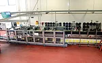 30 wine bottles are vertically loaded through plastic fingers that guide the bottles into the cases
