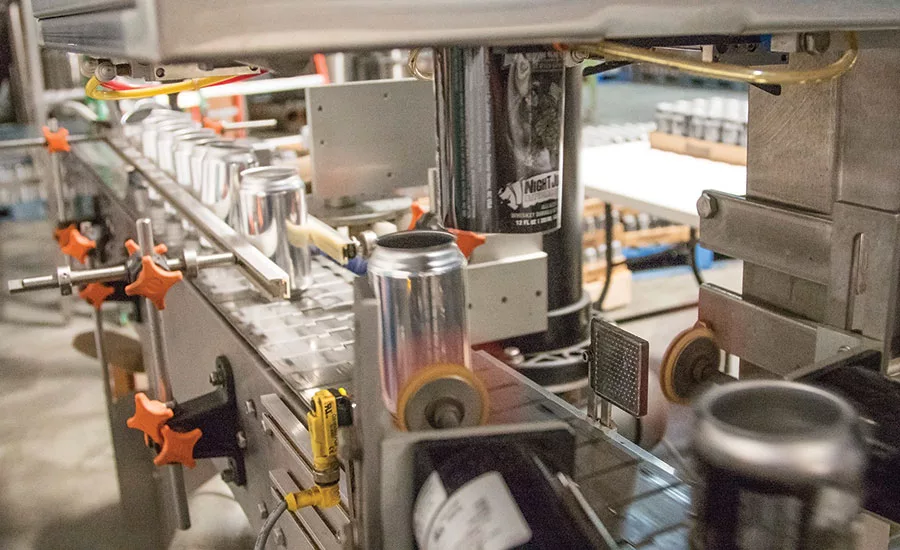 Axon EZ-100 Shrink Sleeve Applicator applying labels to cans