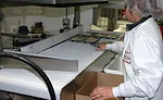 Trays arrive to the pack station properly oriented, making it easier and quicker for employees to handle and pack