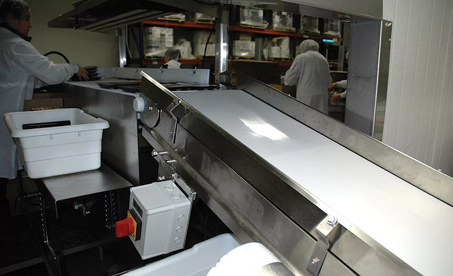 The 4-foot long conveyor brings packaged cheese up to proper height for handling