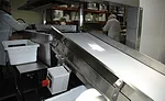The 4-foot long conveyor brings packaged cheese up to proper height for handling