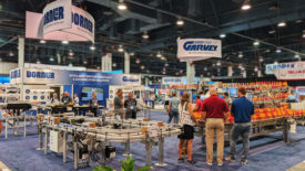 PS 1223 Conveyors features Dorner GarveyPack Expo opening image. PACK EXPO attendees visiting the Dorner and Garvey booth.
