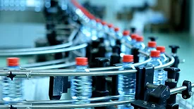 2024 State of Converting feature image of water bottles on a conveyor in a factory.