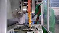 An automated packaging machine is being utilized to pack savory snacks.