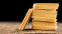 Packaged cheese (sliced) on an old wooden table as a detailed close-up shot.