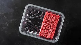 Ground beef in Klöckner Pentaplast tray with a black background.