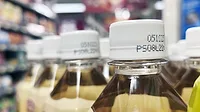 Close-up of bottles of drinks in a supermarket.