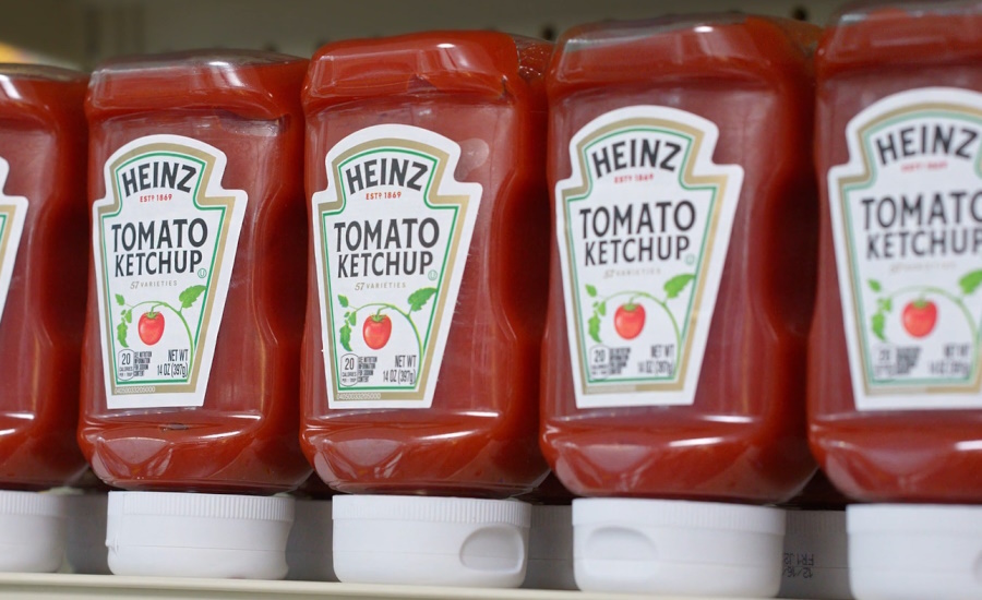 Image of bottles of Heinz tomato ketchup on retail shelf.