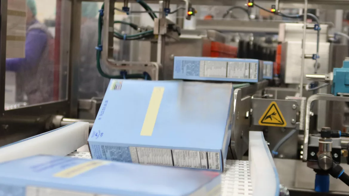 A bag-in-box product moves down the conveyor of the Alterion CL-170 cartoner at the GreenSeed plant.