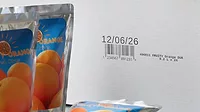 Domino printed white box with juice pouches to its left 