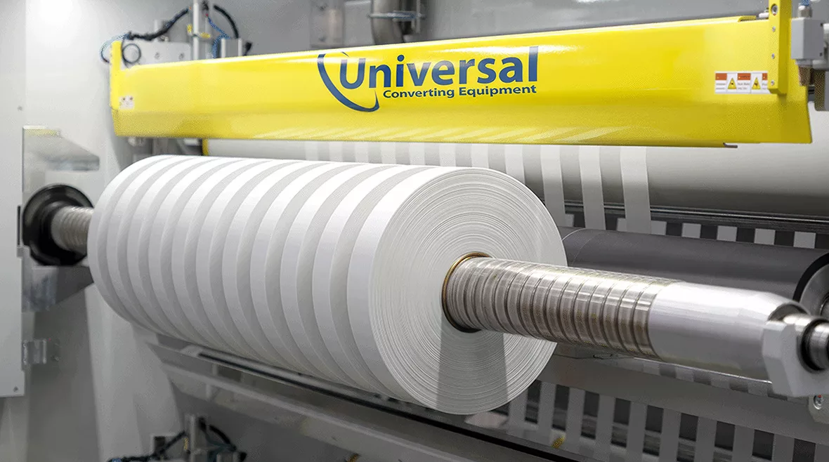 Universal X8 A high-precision demonstration of the Universal X8 performing narrow-web slitting and rewinding on a white substrate.